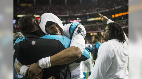 Cam Newton and Ron Rivera following the Falcons win (2013).webp